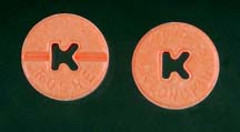 Photo of two orange pills with a 'K' stamped through the center.