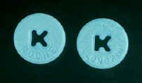 Photo of two blue pills with a 'K' stamped through the center.