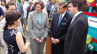 David Sampson, deputy secretary of commerce (second from right) with officials in Baku, Azerbaijan, on June 4, 2007. Behind them is a specially outfitted bus donated by McDonalds to a center for handicapped children. (U.S. Department of Commerce photo) 