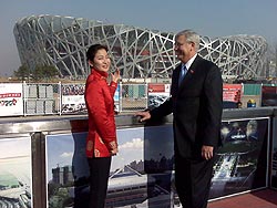 photo of the Administrator and a host overlooking the Olympic venue in the background