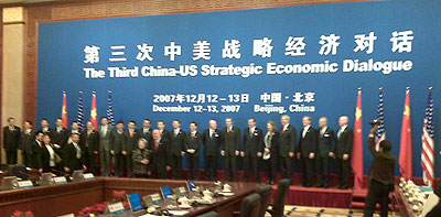 wide photo showing the plenary meeting hall, the sign says The Third US-China Strategic Economic Dialogue (in Chinese and English)