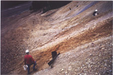 U.S. Geological Survey Scientists sampling water drainage on mine dump.
