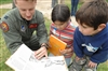 Capt. Ryan Freeman shows a school book to Chilean children.