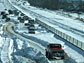Photo of automobiles stuck on a highway during a snow storm.