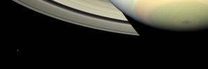 Cassini takes in a sweeping view of Saturn's south polar region as the planet's shadow masks the rings and bright, icy Mimas looks on from left