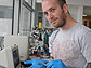 John Chmiola holds an electrochemical capacitor's electrode produced from titanium-derived carbon.