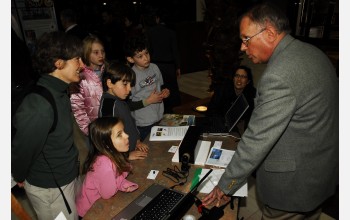 Photo of group at compact portable cosmic ray detector exhibit