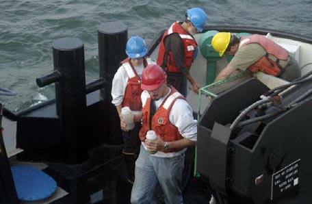 photo: Students collect samples of organisms dwelling in the bottom sediments of Lake Michigan (photo courtesy of William M. Kane)