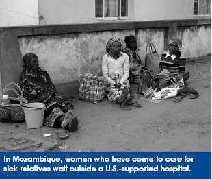 In Mozambique, women who have come to care for sick relatives wait outside a U.S.-supported hospital