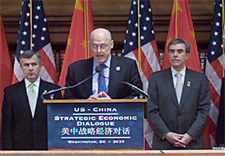 U.S. officials surround Secretary Paulsen on the dais. Click for larger image.