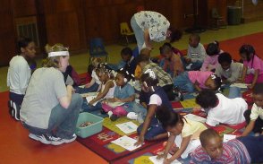 VISTA volunteer teaching children about the dangers of lead