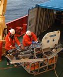 Dann Blackwood and Marshall Swartz prepare to deploy TOWCAM, a camera sled designed to photograph the sea floor in deep-water areas. 