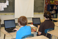 Photo of middle school students using math software.