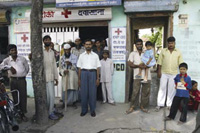 Dr Siddiqui (center), DOTS provider and General Physician outside his clinic in Sahaspur Village, India.