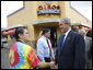 President George W. Bush shakes hands with Betty Garza, owner of Olmos Pharmacy, during his visit to establishment Monday, Oct. 6, 2008, in San Antonio, Texas. The Pharmacy -- no longer a pharmacy -- is known for its hamburgers and milkshakes and prior to becoming its owner, Ms. Garza served as its counter waitress for more than 35 years. White House photo by Eric Draper