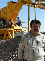 Photo of Abu Yahya, who used a USAID business development grant to purchase a stone crusher and generator. Click for story