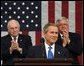 President George W. Bush reacts to applause while delivering the State of the Union address at the U.S. Capitol, Tuesday, Jan. 28, 2003. Also pictured are Vice President Dick Cheney, left, and Speaker of the House Dennis Hastert.  White House photo by Eric Draper