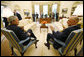 President George W. Bush and U.S. Treasury Secretary Henry Paulson talk together during their meeting on economic issues Monday morning, May 19, 2008, in the Oval Office. White House photo by Eric Draper