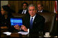 President George W. Bush holds up a computer with the E-Budget for the cameras during a Cabinet meeting Monday, Feb. 4, 2008. Later, the President said, "I submitted the budget today to Congress -- it's on a laptop notebook, an e-budget. It saves paper, saves trees, saves money. I think it's the first budget submitted electronically. And it's a good budget. It's a budget that achieves some important objectives. One, it understands our top priority is to defend our country, so we fund our military, as well as fund the homeland security. Secondly, the budget keeps our economy growing." White House photo by Joyce N. Boghosian