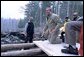 President George W. Bush takes a working tour of The Adirondack Park near Wilmington, NY, Monday, April 22. "We had a great time in the Park, and I want to thank you all very much for giving me the opportunity to hammer and stack, place gravel -- (laughter) -- in a beautiful part of the world. This is quite a sight for a fellow from Texas," said the President in his remarks about Earth Day at Whiteface Mountain Lodge. "We have a duty in our country to make sure our land is preserved, our air is clean, our water is pure, our parks are accessible and open and well- preserved." White House photo by Eric Draper.