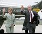 President George W. Bush and Mrs. Bush wave as they walk to Air Force One with Barney before departing Waco, Texas, Thursday, July 29, 2004.  White House photo by Eric Draper