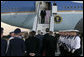 President George W. Bush and Laura Bush are greeted as they arrive Wednesday, July 12, 2006, at Rostock-Laage Airport in Rostock, Germany. The couple later boarded Marine One for a short ride to Heiligendamm, where they are the guests of Germany's Chancellor Angela Merkel before proceeding Friday to the G8 Summit in Russia. White House photo by Eric Draper