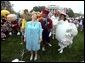 Accompanied by all sorts of story book characters, Lynne Cheney the host of the 2003 White House Easter Egg Roll, addresses the media on the South Lawn Monday, April 21, 2003. "But most of all, we are proud of all of you, the men and women who serve our country, who keep our country free," said Mrs. Cheney in her opening remarks welcoming U.S. military families to the event. File Photo.  White House photo by David Bohrer