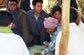Photo of a Cambodian community leader helping villagers identify their property boundaries 