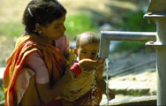 Woman gives her child a drink at a safe water source.  Photo: USAID/Asia.  Click here to read more about USAID in India.