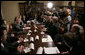 President George W. Bush answers a question from the press as he sits with members of the insurance, banking and business communities Tuesday, April 4, 2006, during a meeting at the White House on Health Care Initiatives.  White House photo by Paul Morse