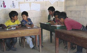 Guatemalan students develop new reading and writing skills in small groups.