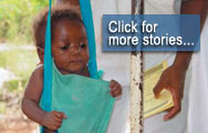 Mozambique - A health worker weighing a baby  ...  Click for more stories...