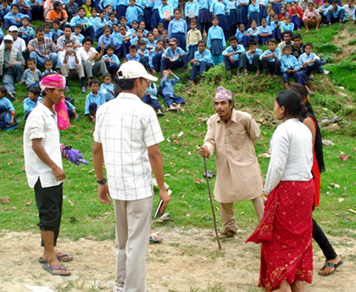 Artists perform a street drama on peace and reconciliation at the local level.