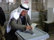 Elderly Palestinian gentleman putting his ballot in a ballot box, in the Bethlehem area, on election day.
