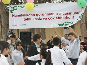 At Mahammedi's first-ever community health fair, young men and women received information on reproductive health and family planning. The banner above the dance area reads, 'Modern methods of pregnancy prevention are safe and effective.'