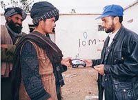 IOM worker distributing radios in Afghanistan