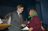 E&E Senior Deputy Administrator Drew Luten distributes land titles at a ceremony held by the Malyn village council