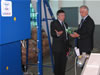 Douglas Menarchik (right) and Dumitru Vicol, Monicol Fruit Drying Facility Director, discussing the capacities of the company's packing line