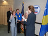 Administrator Henrietta H. Fore (right) administers the Oath of Office to Patricia L. Rader (center), at her swearing-in ceremony on September 10 as the new Mission Director for USAID/Kosovo while her family looks on. From rear left: John Rader (Rader's brother) of Springfield, VA, Debra Crandall (Rader's sister) of Fayetteville, AR, and Dorothy Rader (Rader's mother) of Fayetteville, AR.