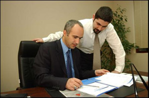 Photo: Bashar Amad, one of Jordan’s first Chartered Financial Analyst charterholders, explains the program to a client.

