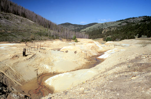 Photo of tailings filling High Ore Creek valley at Comet Mine in 1997 before removal.