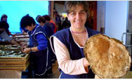 An employee of Mushroom, in Celinac, Bosnia-Herzegovina, shows off one of her company's more impressive harvests - Click to read this story
