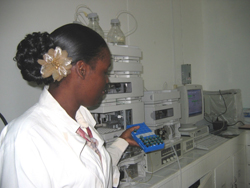 A technician at the Guyana Food and Drug Department Lab in Georgetown, Guyana selects samples to be tested with new equipment.