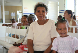 Jacinta Morla and her granddaughter wait in the recently remodeled waiting room at Alejo Martinez Hospital in Ramón Santana, Dominican Republic.