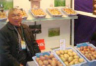 A farmer displays new potato varieties at the first annual “Silk Road” Ferghana Valley International AgriExpo, organized by the agribusiness association with USAID assistance.