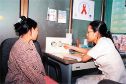 A housewife is educated from a RHAC clinic doctor.