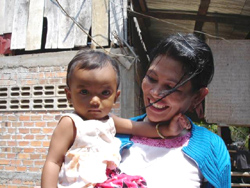 Phally plays with her niece in Battagram, western Cambodia. After her husband died of HIV/AIDS, Phally learned that she too was HIV-positive.