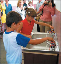 Photo: Students at Comanca School try out the new water system.