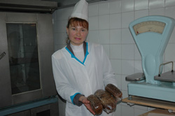 Victoria Nikitina shows samples of fresh bread at her Ukraine bakery