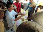 An image of an outreach worker in Guangxi Province, China, teaching stevedores about HIV/AIDS and sexually-transmitted diseases